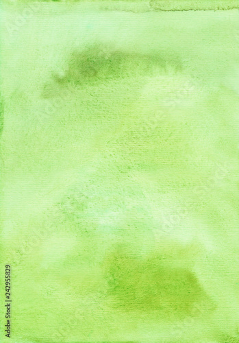 Light green watercolor background painted on textured paper. Greenery color trend backdrop. Bright green aquarelle template. Green watercolor paint stains on paper. Cards, invitations, wallpaper.