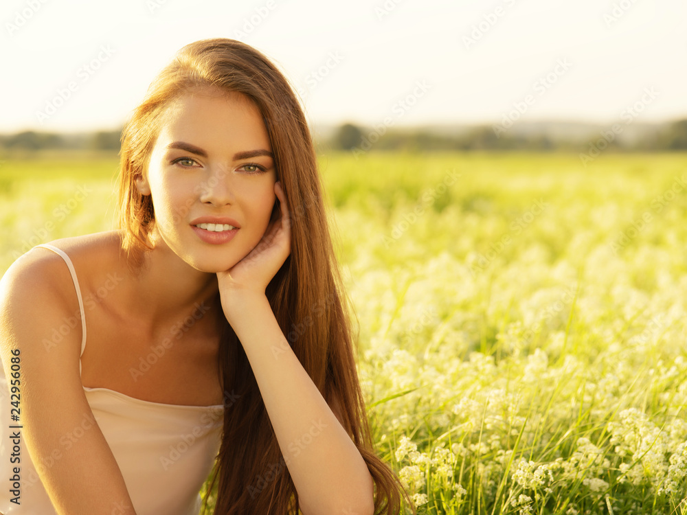 Beautiful young woman on nature over summer field background Beautiful young woman on nature over summer field background
