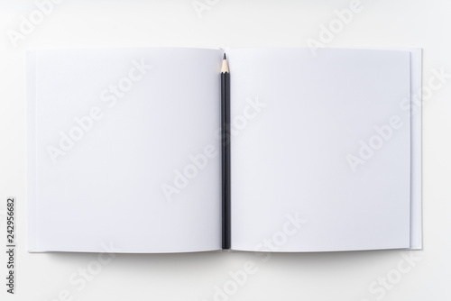 Top view of white notebook, page, pencil © voyata