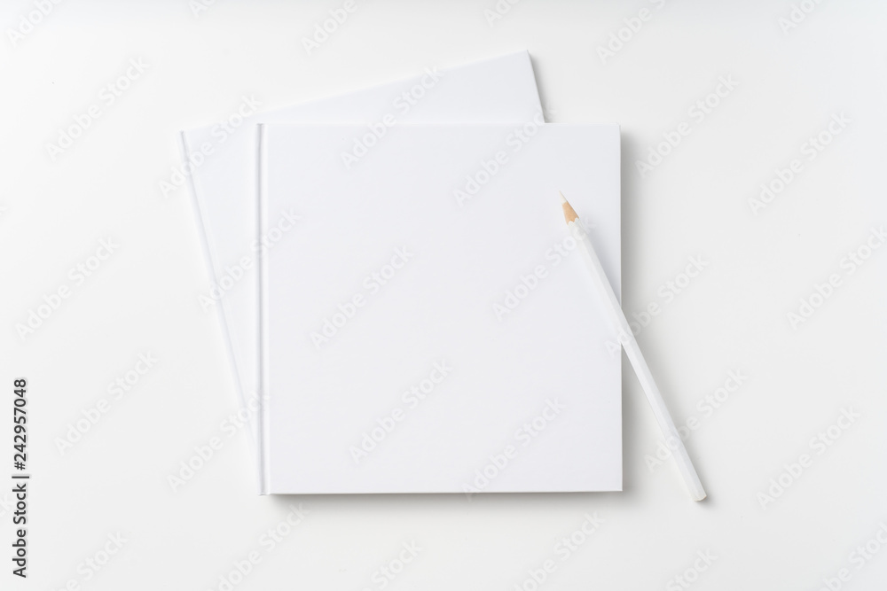 Top view of 2 white hardcover notebook, pencil Top view of 2 white hardcover notebook, pencil