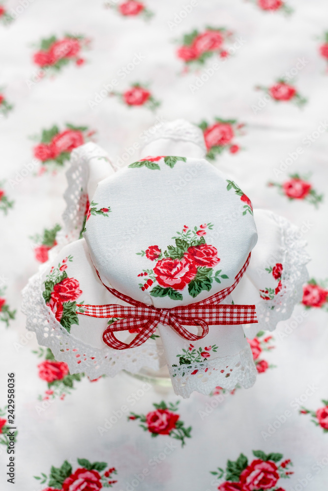 Decorative handmade textile jar cover with gingham red ribbon Decorative handmade textile jar cover with gingham red ribbon