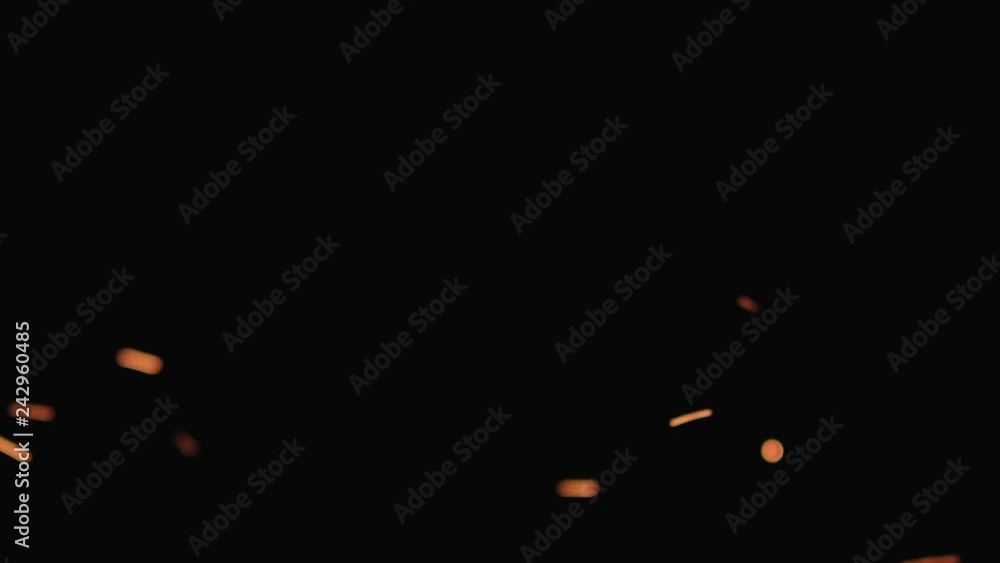 Slow motion hot sparks floating from side on black background, 180fps Slow motion hot sparks floating from side on black background, 180fps