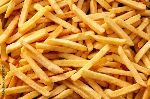Photo Overhead view of golden deep fried French fries food in full frame closeup