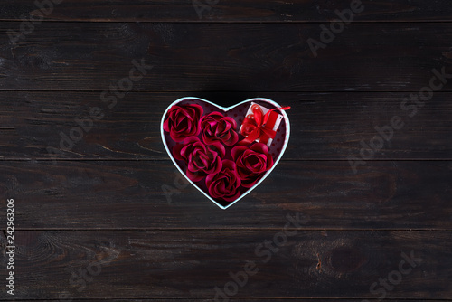 Valentines background with red hearts shaped and bouquet rose in gift box on dark wooden background  flat lay copy space