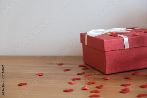 Valentine present. Gift box and red ribbon for romantic couple.