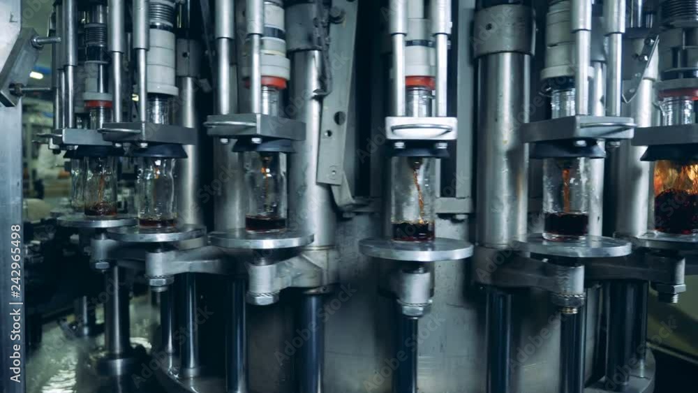 Rotating conveyor and glass bottles getting filled with liquid Rotating conveyor and glass bottles getting filled with liquid