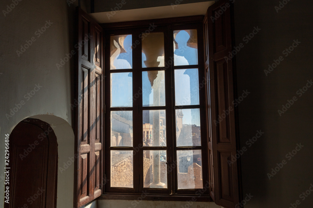 Obraz premium Window with views of the castle and a church