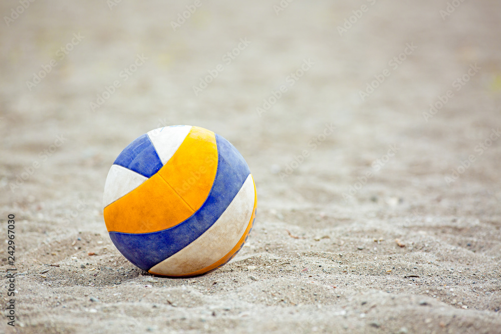 Beach Volleyball. Game ball under sunlight and blue sky. Volleyball in the sand at the beach