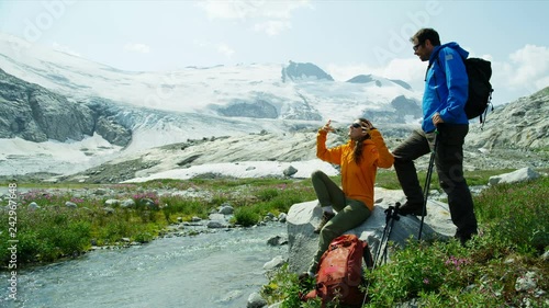 Young Heli hikers Caucasian couple scenic lake Canada photo