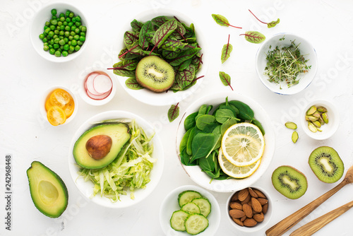 Clean food. Fresh raw vegetables and lettuce leaves to prepare a healthy snack meal salad. Top view. On a light background.