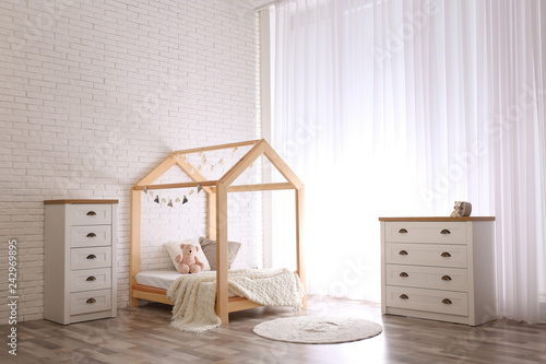 Stylish kid s room interior with cute wooden bed
