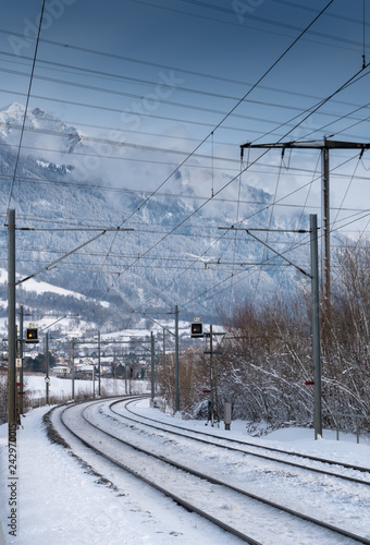 train tracks in the Swiss countryside covered in snow in deep winter