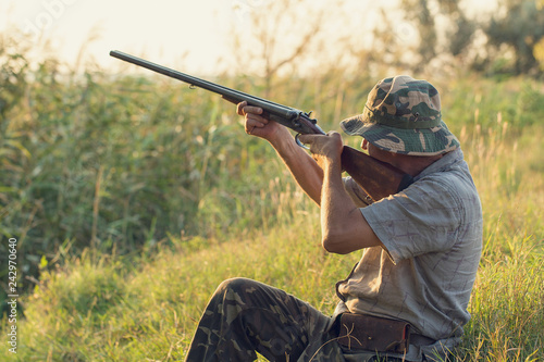 Hunter with a german drathaar and spaniel, pigeon hunting with dogs in reflective vests