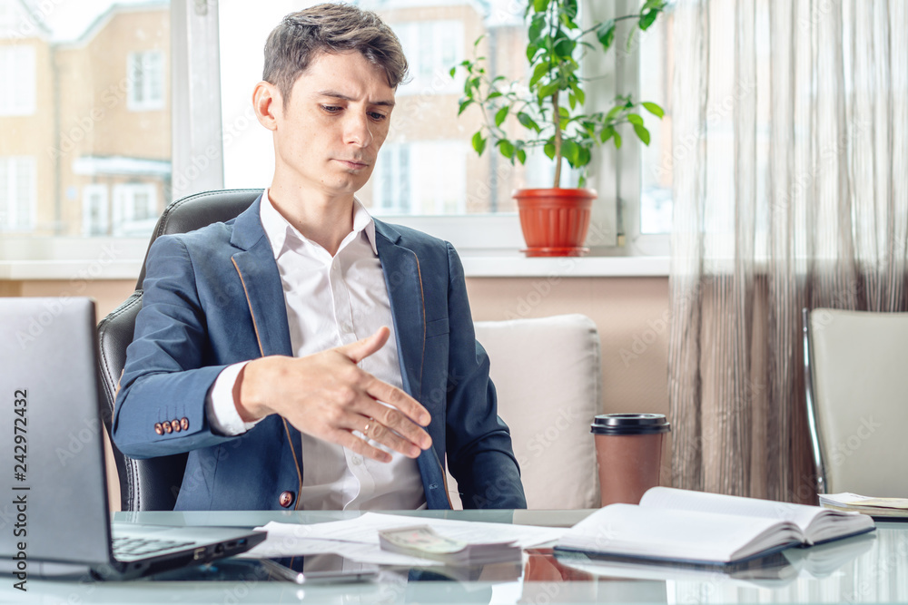 Official businessman sitting at workplace in office refuses bribes. Concept of corruption and bribery Official businessman sitting at workplace in office refuses bribes. Concept of corruption and bribery