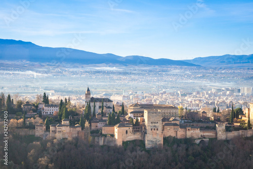 Morning view over Granada city and Alhambra castle on Sierra Nevada mountains background. Spain.