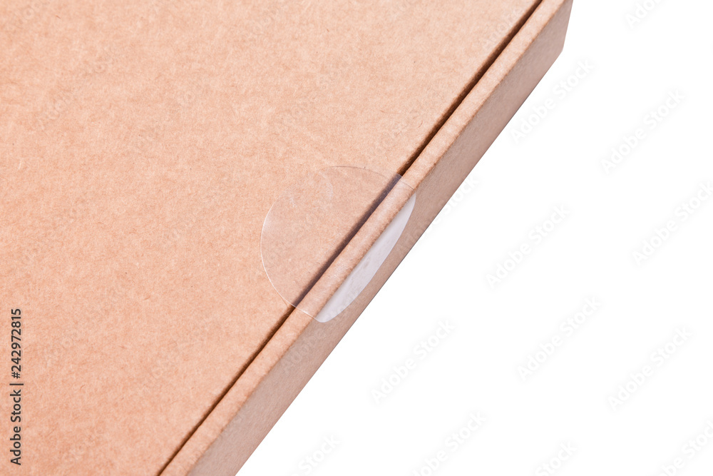 Round Clear Package Seal Label Sticker on cardboard box Stock Photo