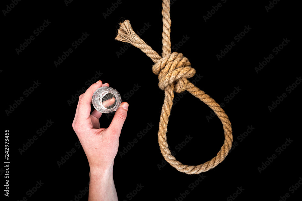 Rope, pills and glass of alcohol (vodka) on black background. Suicide. Running knot. 