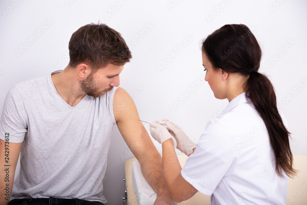 Doctor Injecting Syringe To Patient Doctor Injecting Syringe To Patient