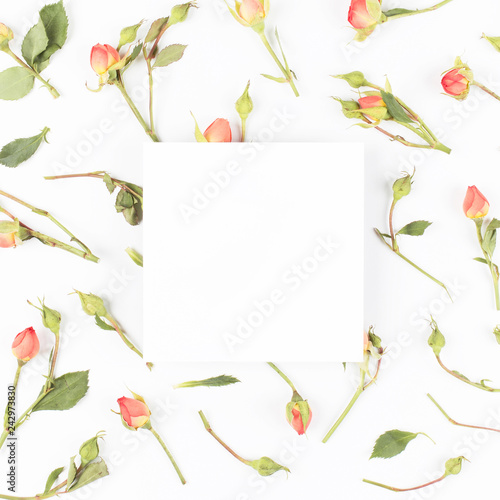 Fototapeta Naklejka Na Ścianę i Meble -  Floral pattern made of pink roses, green leaves, branches on white background.  Flat lay, top view. Floral background. Valentine's background.