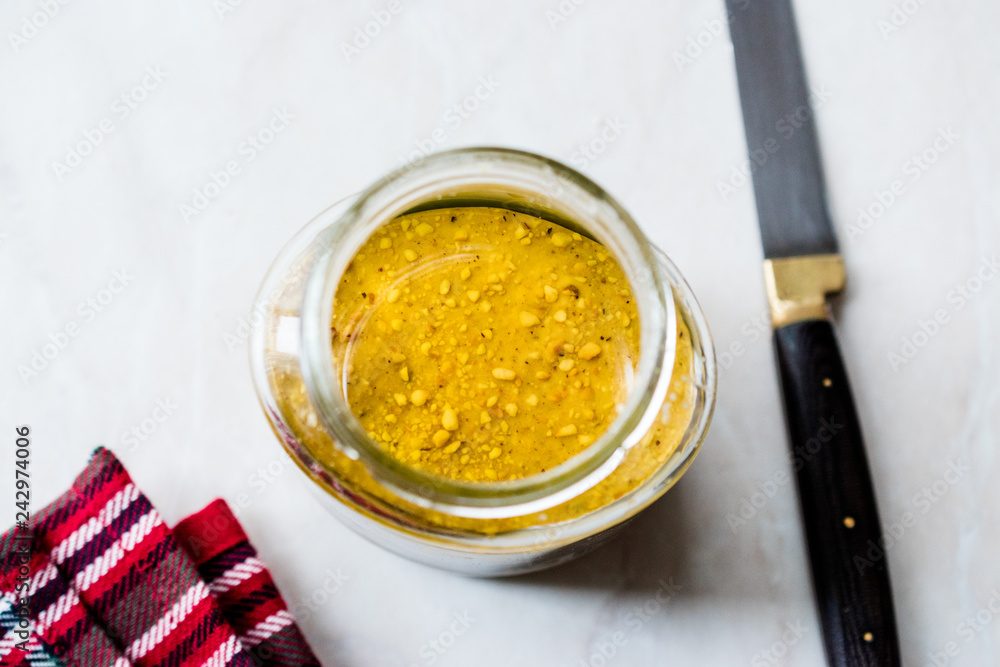 Jar Of Peanut Butter with Knife for Breakfast on Marble Surface. Jar Of Peanut Butter with Knife for Breakfast on Marble Surface.