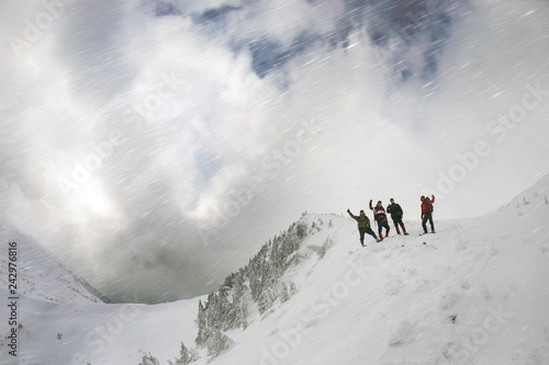 tourists on a snowy slope © panaramka