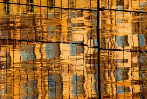 Reflection of an orange high-rise building in the water