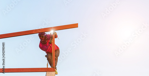 Fototapeta Naklejka Na Ścianę i Meble -  Construction worker welding steel for roof structure