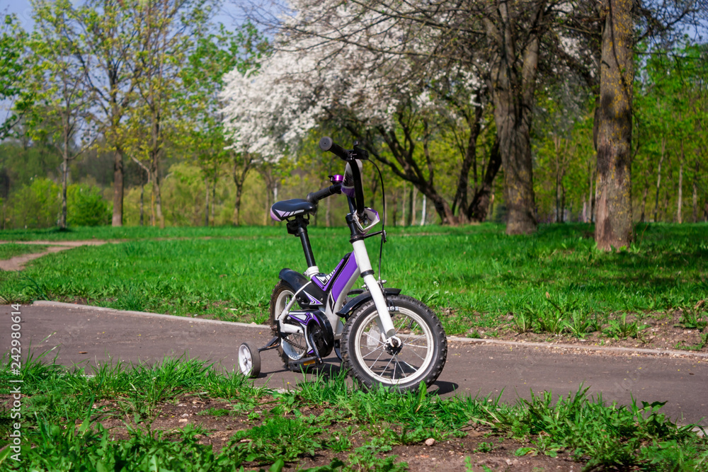two-wheeled white-purple bike with extra side wheels two-wheeled white-purple bike with extra side wheels