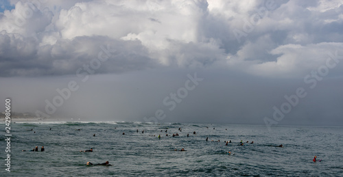 clouds over sea surfers 