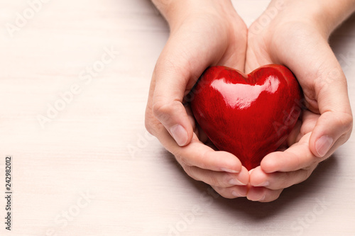 Red wood heart in child hands