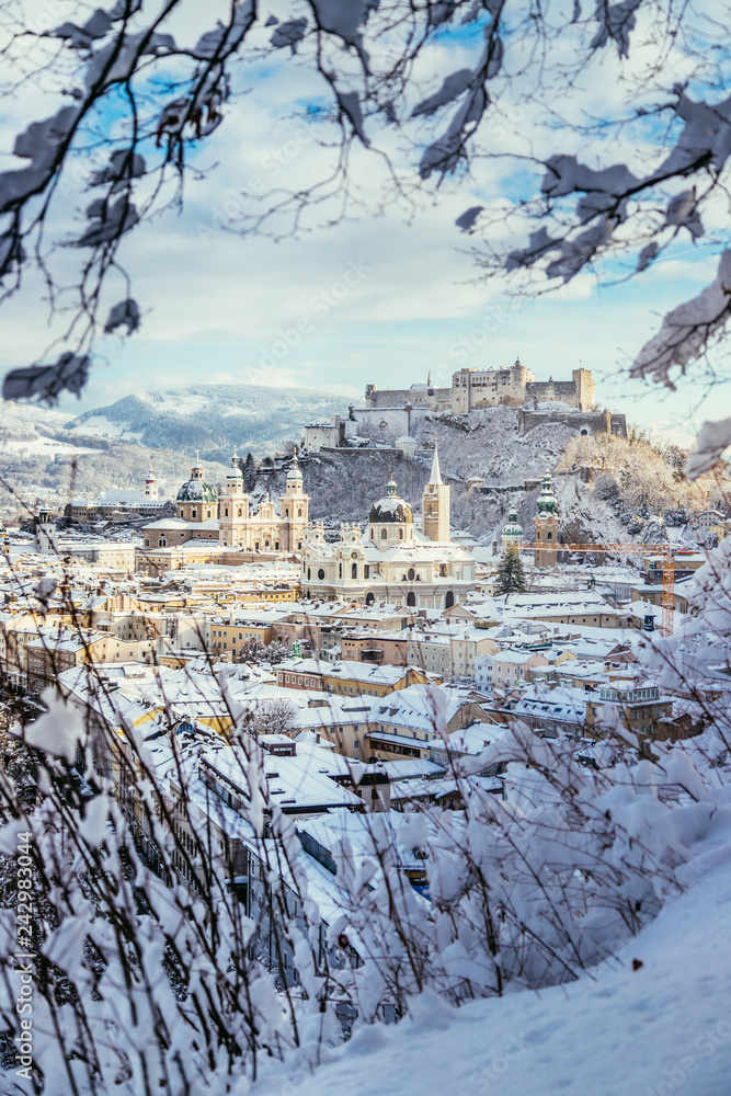 Fototapeta premium Panorama of Salzburg in winter: Snowy historical center, sunshine