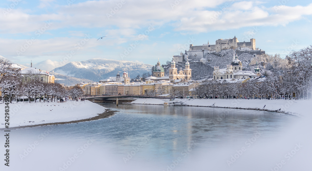 Fototapeta premium Panorama of Salzburg in winter: Snowy historical center, sunshine