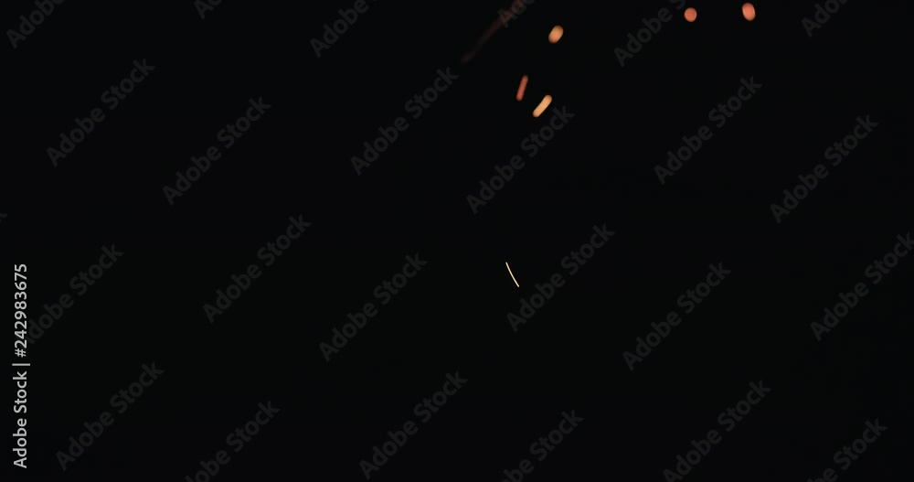 Slow motion hot sparks falling from above black background, 60fps Slow motion hot sparks falling from above black background, 60fps