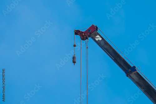Crane Hook lifting for construction on blue sky,steel hook and chain, copy space
