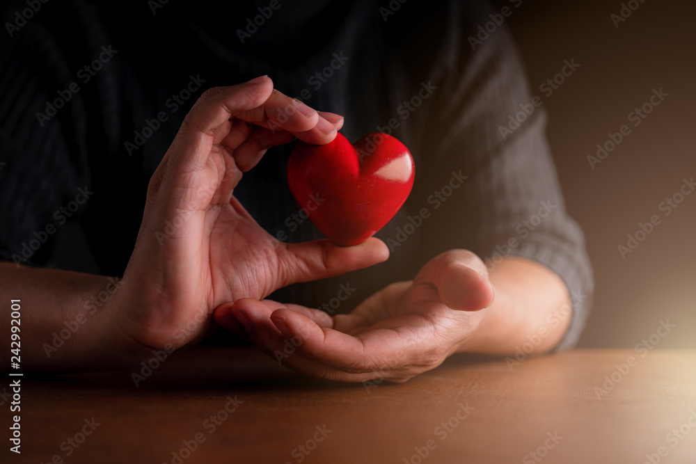 love valentine concept man hand touch red heart shape object with care and happiness
