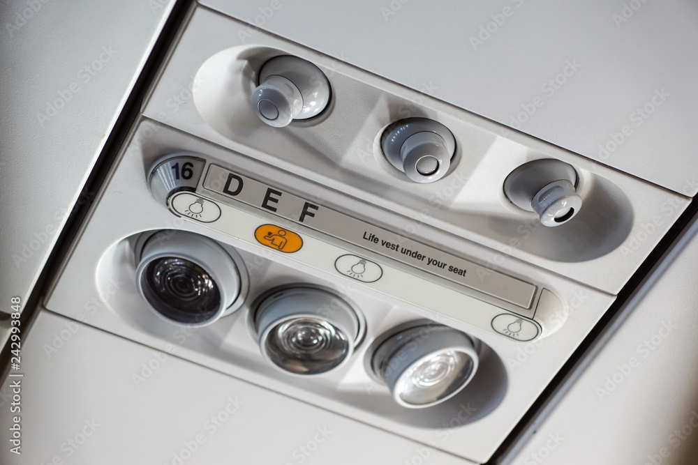 Cabin inside the aircraft, lights, air condition and signs panel above the seat Cabin inside the aircraft, lights, air condition and signs panel above the seat