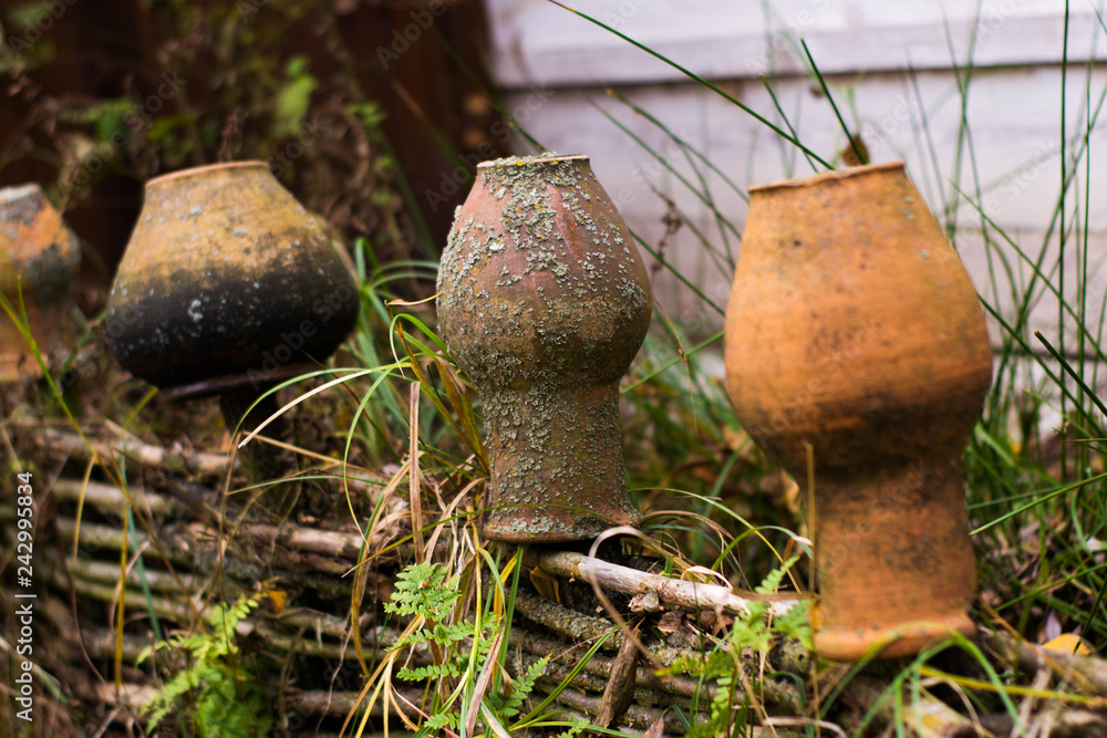 Old inverted jugs on the fence close-up. Old Russian village traditions Old inverted jugs on the fence close-up. Old Russian village traditions