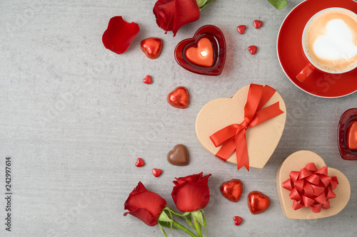 Valentine's day background with coffee cup, heart shape chocolate, candles and gift boxes.