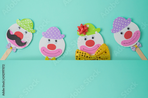 Jewish holiday Purim background with cute paper clowns characters.