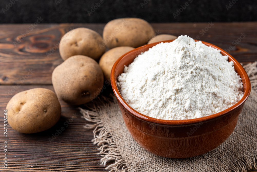 Potato starch on dark wooden background. Potato starch on dark wooden background.
