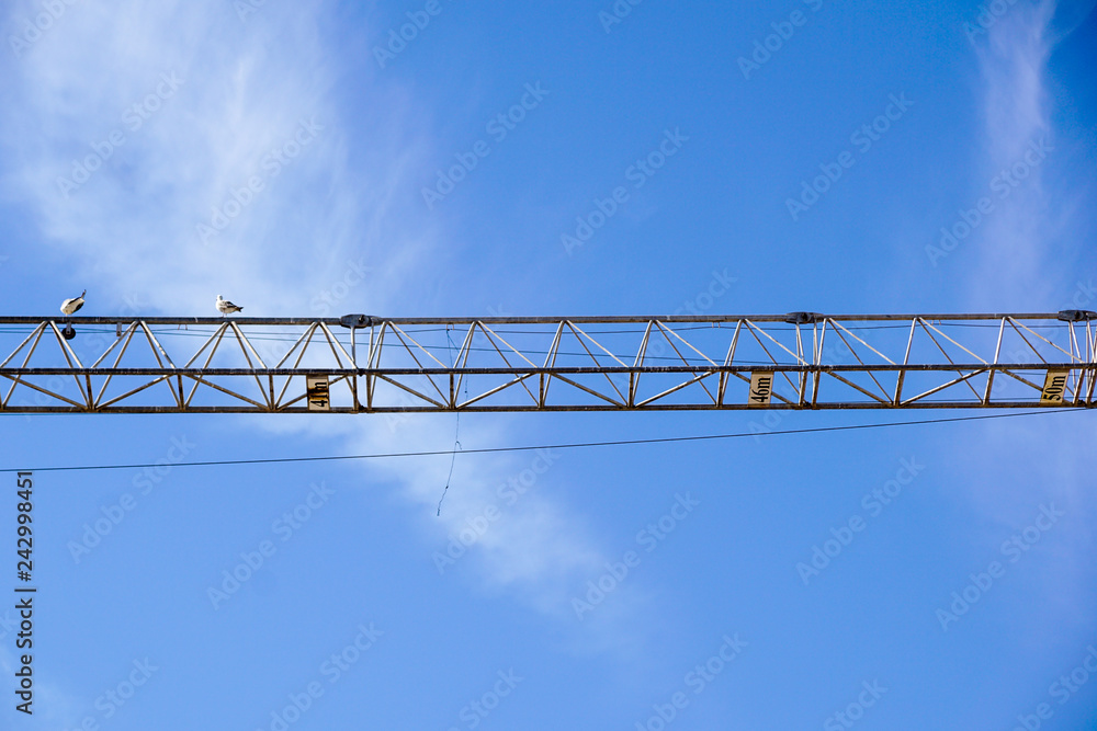 part of arm machinery construction crane with blue sky background part of arm machinery construction crane with blue sky background