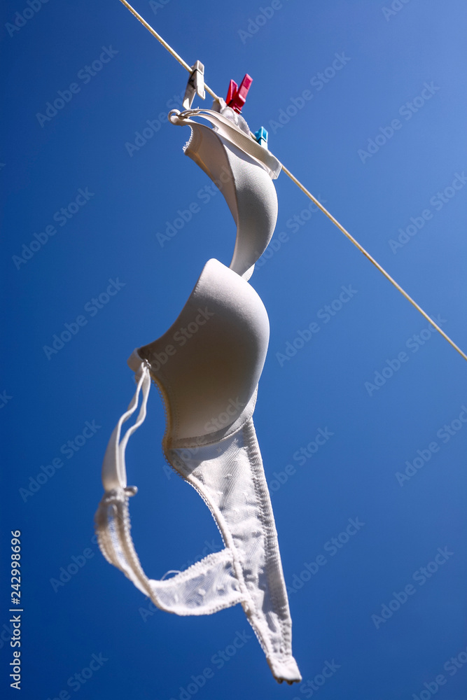 White bra drying on a washing line Stock Photo