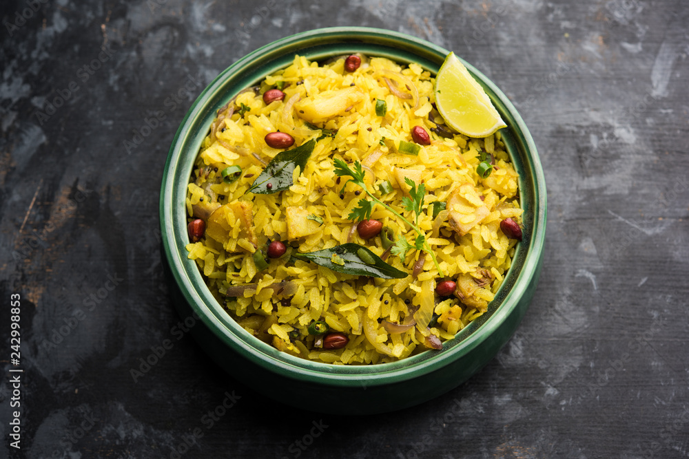 Aloo/Kanda Poha or Tarri Pohe with spicy chana masala/curry. selective focus Aloo/Kanda Poha or Tarri Pohe with spicy chana masala/curry. selective focus