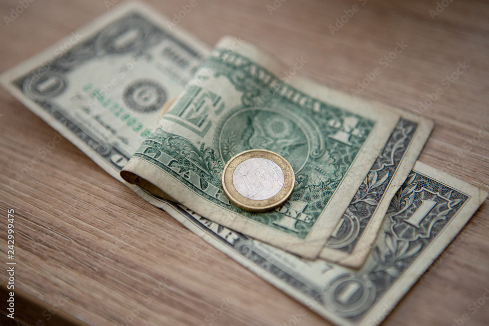 Euro coins on US paper US dollars Euro coins on US paper US dollars
