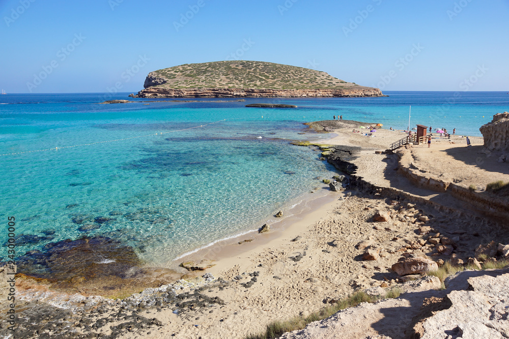 Beautiful sandy Cala Comte beach with azure blue sea water, Ibiza island, Spain