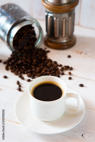 cup of coffee and beans on white background