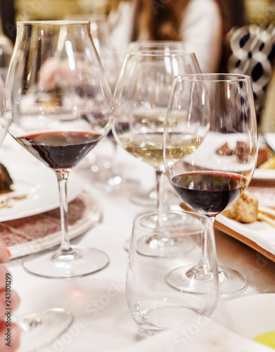 Many glasses of different wine in a row on a table. Tasting wine concept