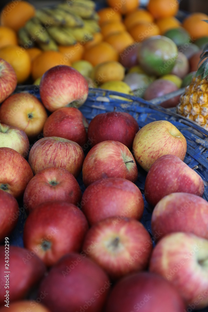 On the counter are such fruits as bright apples and a large pineapple On the counter are such fruits as bright apples and a large pineapple