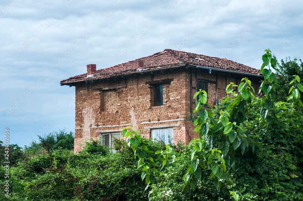 Old abandoned weathered retro vintage rural brick wall house