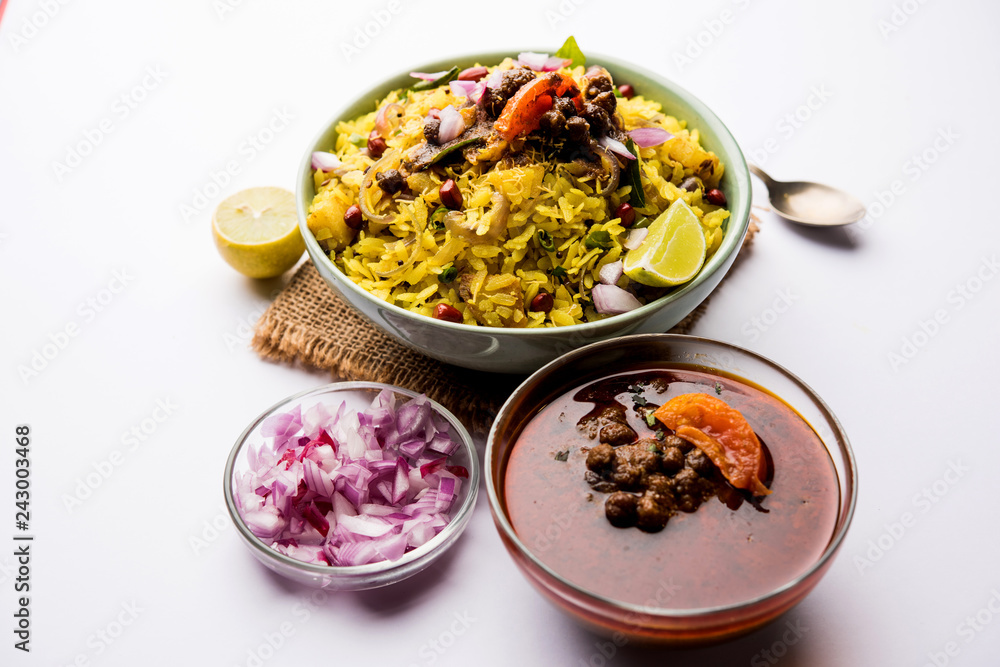 Aloo/Kanda Poha or Tarri Pohe with spicy chana masala/curry. selective focus Aloo/Kanda Poha or Tarri Pohe with spicy chana masala/curry. selective focus